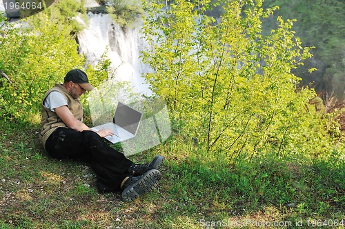 Image of man outdoor laptop