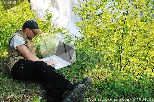 Image of man outdoor laptop