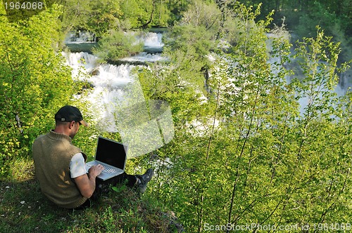 Image of man outdoor laptop