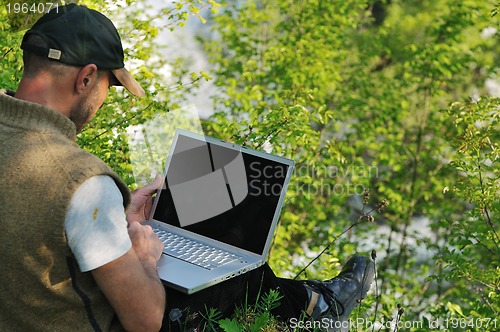 Image of man outdoor laptop