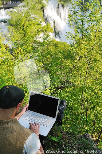 Image of man outdoor laptop