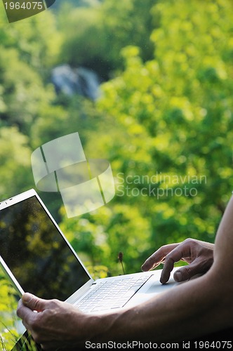 Image of man outdoor laptop