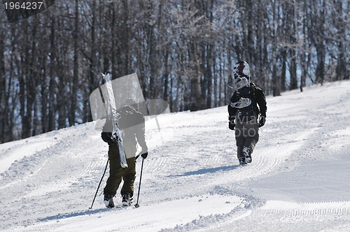 Image of skier hike on mountain peak at winter