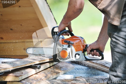 Image of wood worker with chainshaw closeup