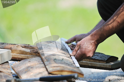 Image of wood worker with chainshaw closeup