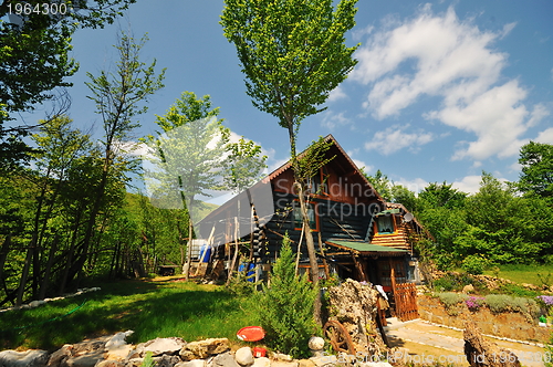 Image of wooden country house with beutiful garden