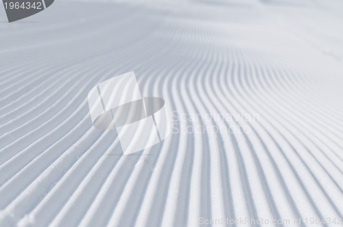 Image of tracks on ski slopes at beautiful sunny  winter day