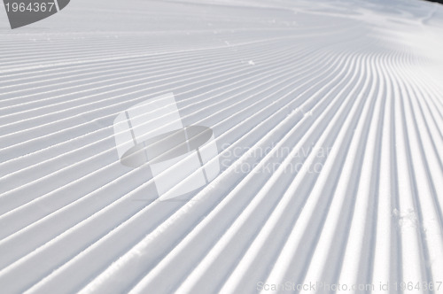 Image of tracks on ski slopes at beautiful sunny  winter day