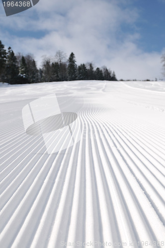 Image of tracks on ski slopes at beautiful sunny  winter day