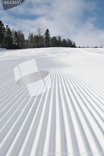 Image of tracks on ski slopes at beautiful sunny  winter day