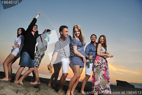 Image of Group of young people enjoy summer  party at the beach