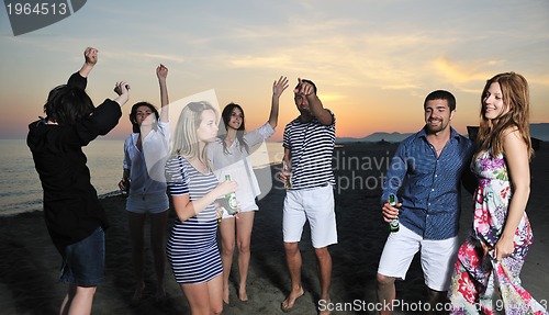 Image of Group of young people enjoy summer  party at the beach