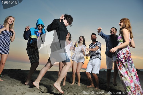 Image of Group of young people enjoy summer  party at the beach