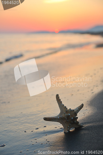 Image of summer beach sunset with star on beach