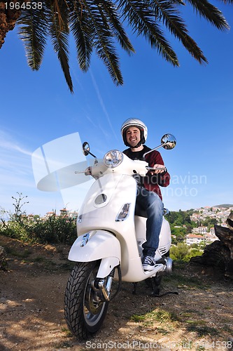 Image of Portrait of happy young love couple on scooter enjoying summer t