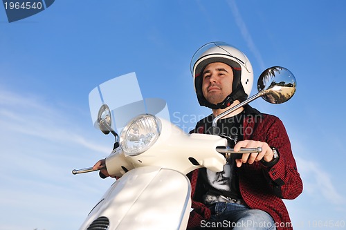 Image of young man on ride scooter