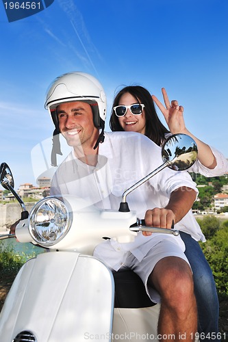 Image of Portrait of happy young love couple on scooter enjoying summer t