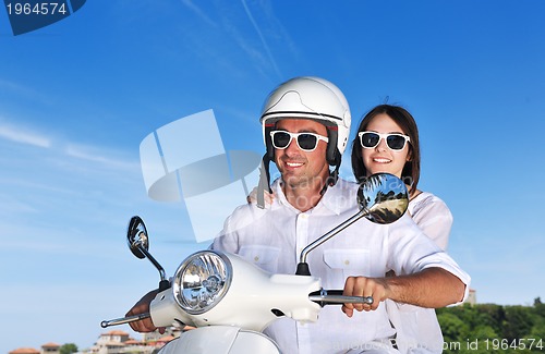 Image of Portrait of happy young love couple on scooter enjoying summer t