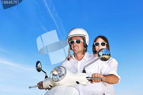 Image of Portrait of happy young love couple on scooter enjoying summer t