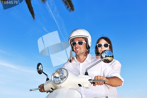 Image of Portrait of happy young love couple on scooter enjoying summer t