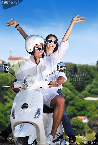 Image of Portrait of happy young love couple on scooter enjoying summer t