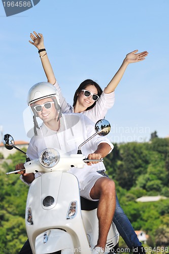 Image of Portrait of happy young love couple on scooter enjoying summer t