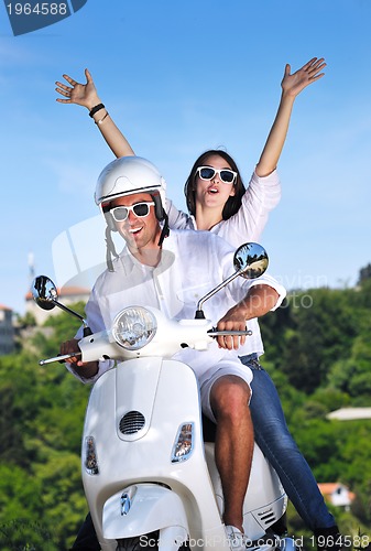 Image of Portrait of happy young love couple on scooter enjoying summer t