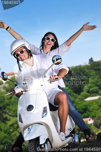 Image of Portrait of happy young love couple on scooter enjoying summer t