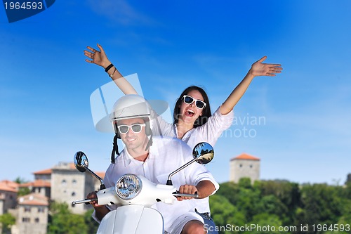 Image of Portrait of happy young love couple on scooter enjoying summer t