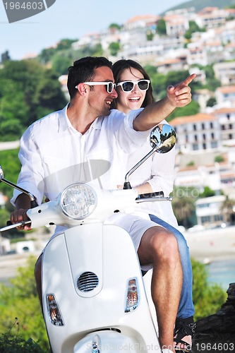 Image of Portrait of happy young love couple on scooter enjoying summer t