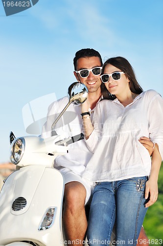 Image of Portrait of happy young love couple on scooter enjoying summer t