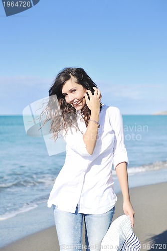 Image of happy young woman on beach