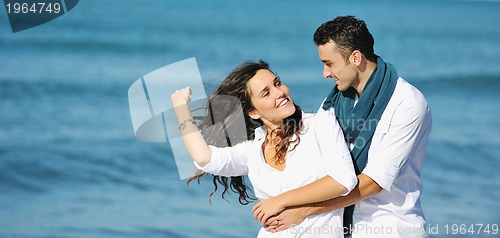 Image of happy young couple have fun at beautiful beach