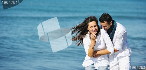Image of happy young couple have fun at beautiful beach