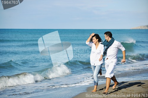 Image of happy young couple have fun at beautiful beach
