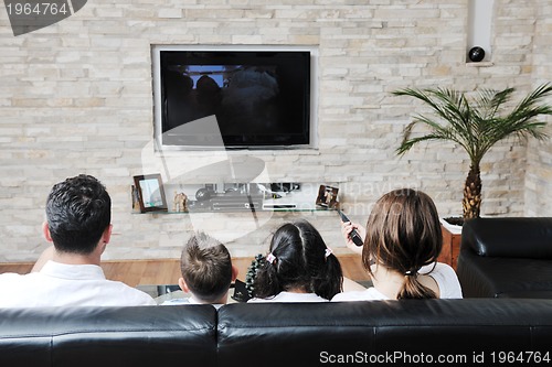 Image of family wathching flat tv at modern home indoor
