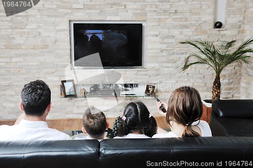 Image of family wathching flat tv at modern home indoor