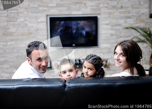 Image of family wathching flat tv at modern home indoor