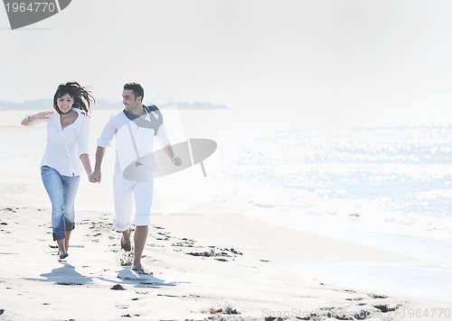 Image of happy young couple have fun at beautiful beach