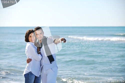 Image of happy young couple have fun at beautiful beach