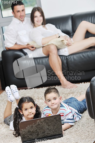 Image of happy young family have fun and working on laptop at home
