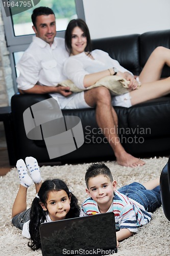 Image of happy young family have fun and working on laptop at home