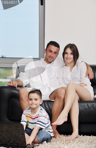 Image of happy young family have fun and working on laptop at home