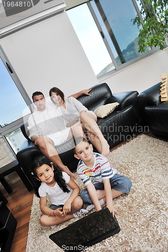 Image of happy young family have fun and working on laptop at home