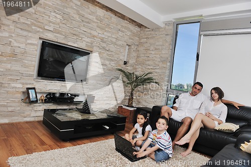 Image of happy young family have fun and working on laptop at home