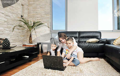 Image of happy young family have fun and working on laptop at home
