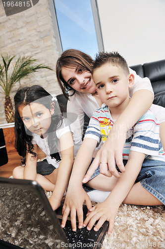 Image of happy young family have fun and working on laptop at home