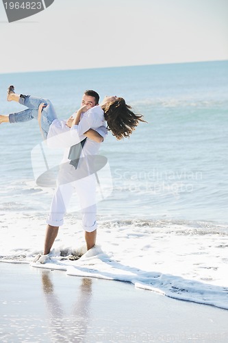Image of happy young couple have fun at beautiful beach