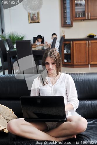Image of happy young family have fun and working on laptop at home