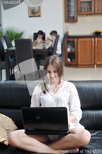 Image of happy young family have fun and working on laptop at home